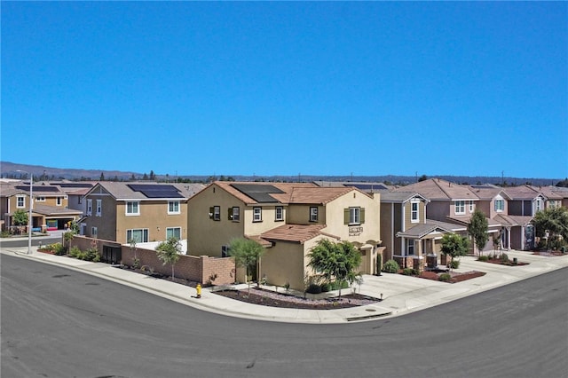 1768 Camellia Ln, Redlands, CA 92374 - multi unit property featuring a residential view, stucco siding, a garage, and concrete driveway