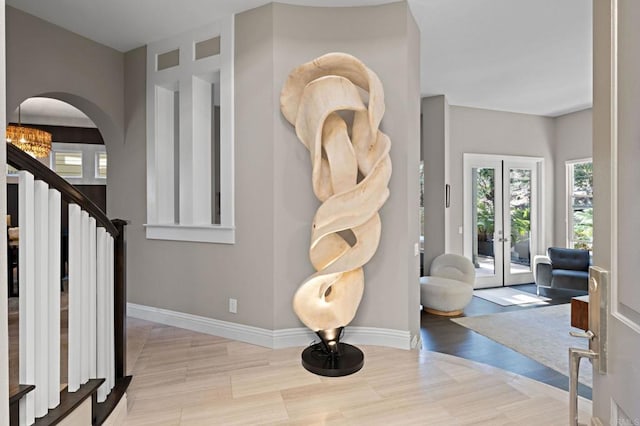 834 S Cedros, Solana Beach, CA 92075 - foyer featuring healthy amount of natural light, arched walkways, stairway, and wood finished floors