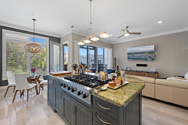 834 S Cedros, Solana Beach, CA 92075 - kitchen featuring stainless steel gas stovetop, healthy amount of natural light, ceiling fan, crown molding, and light stone counters