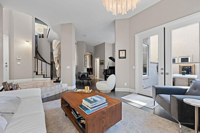 834 S Cedros, Solana Beach, CA 92075 - living area with arched walkways, stairs, wood finished floors, and a chandelier