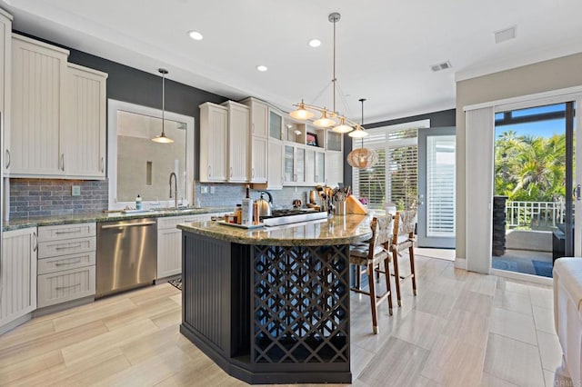 834 S Cedros, Solana Beach, CA 92075 - kitchen with stainless steel dishwasher, recessed lighting, backsplash, light stone counters, and a kitchen bar