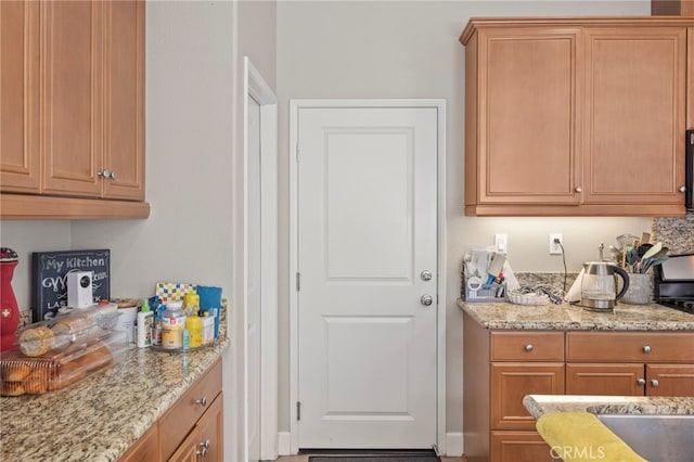 15530 Bonsai Way, Tustin, CA 92782 - kitchen featuring light stone countertops and brown cabinetry
