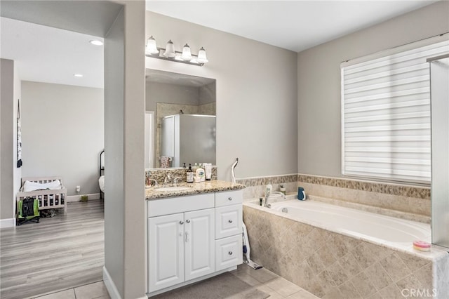 15530 Bonsai Way, Tustin, CA 92782 - bathroom featuring a garden tub, vanity, a stall shower, tile patterned floors, and healthy amount of natural light