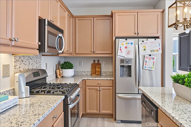 15530 Bonsai Way, Tustin, CA 92782 - kitchen featuring stainless steel appliances, a chandelier, light stone countertops, tasteful backsplash, and pendant lighting