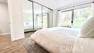 22215 Caminito Vino, Laguna Hills, CA 92653 - bedroom with wood finished floors and access to exterior