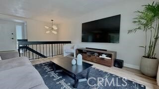 22215 Caminito Vino, Laguna Hills, CA 92653 - living area featuring wood finished floors and a chandelier