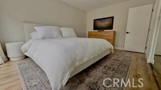 22215 Caminito Vino, Laguna Hills, CA 92653 - bedroom with lofted ceiling and wood finished floors