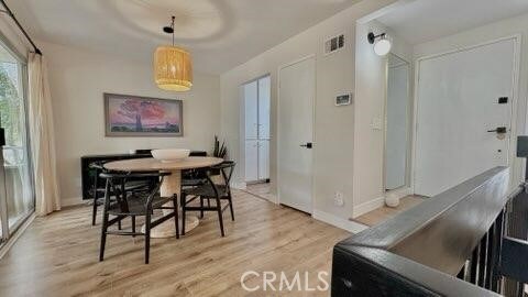 22215 Caminito Vino, Laguna Hills, CA 92653 - dining room featuring light wood-type flooring and baseboards