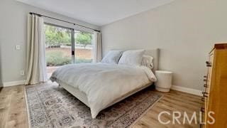 22215 Caminito Vino, Laguna Hills, CA 92653 - bedroom featuring access to exterior and wood finished floors