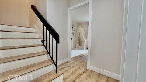 22215 Caminito Vino, Laguna Hills, CA 92653 - stairway with wood finished floors and baseboards