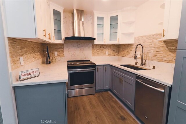 1602 N King St Unit E1, Santa Ana, CA 92706 - kitchen featuring wall chimney exhaust hood, appliances with stainless steel finishes, dark wood finished floors, and white cabinets