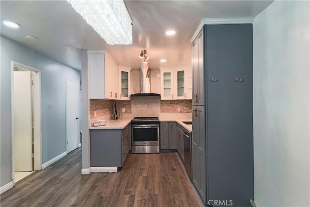 1602 N King St Unit E1, Santa Ana, CA 92706 - kitchen with appliances with stainless steel finishes, wall chimney range hood, gray cabinets, decorative backsplash, and dark wood-style floors