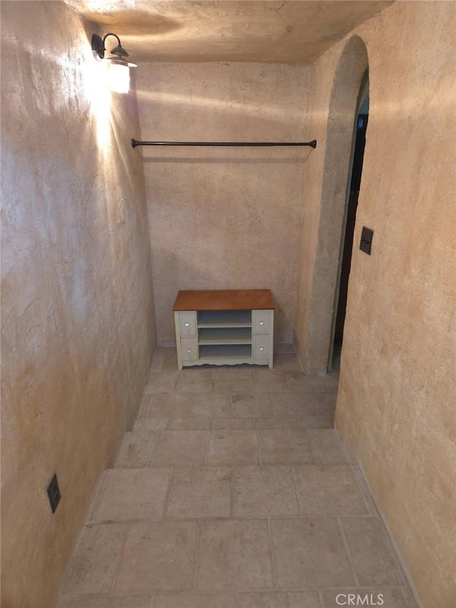 2617 Arbor Dr, Frazier Park, CA 93225 - hall with arched walkways and light stone finish flooring