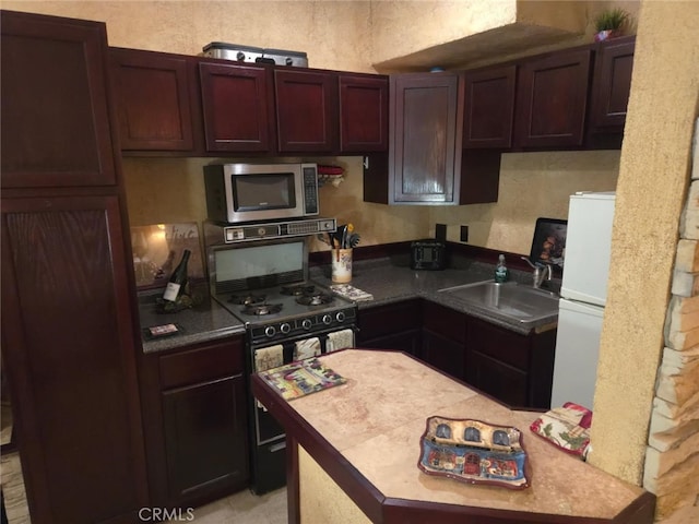 2617 Arbor Dr, Frazier Park, CA 93225 - kitchen with stainless steel microwave, black gas range oven, and freestanding refrigerator