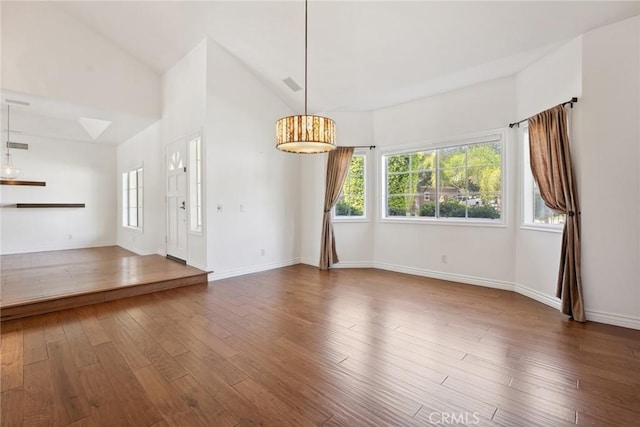 22501 Marilla St, Chatsworth, CA 91311 - spare room with healthy amount of natural light, wood finished floors, and high vaulted ceiling
