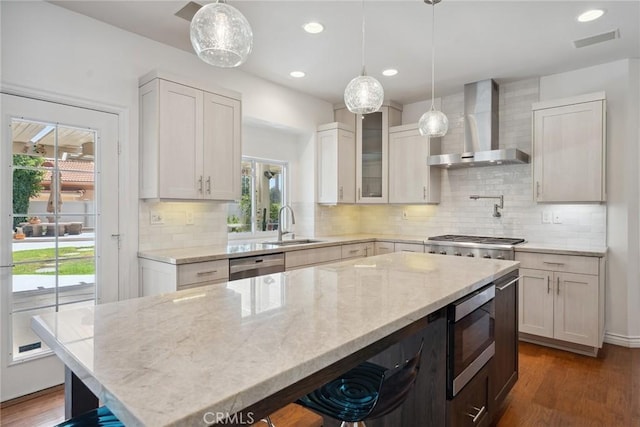 22501 Marilla St, Chatsworth, CA 91311 - kitchen with wall chimney range hood, appliances with stainless steel finishes, wood finished floors, light stone countertops, and white cabinets
