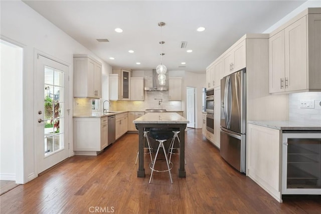 22501 Marilla St, Chatsworth, CA 91311 - kitchen featuring stainless steel appliances, wine cooler, wall chimney range hood, a center island, and decorative backsplash