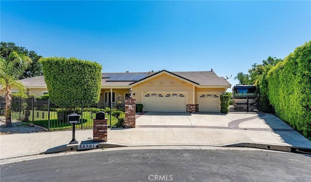 22501 Marilla St, Chatsworth, CA 91311 - view of front facade featuring an attached garage, solar panels, a tile roof, and driveway