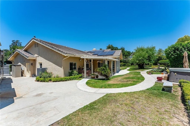 22501 Marilla St, Chatsworth, CA 91311 - ranch-style home with a hot tub, stucco siding, solar panels, a gate, and a patio area