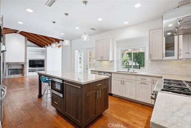22501 Marilla St, Chatsworth, CA 91311 - kitchen with stainless steel appliances, open floor plan, light wood finished floors, tasteful backsplash, and recessed lighting