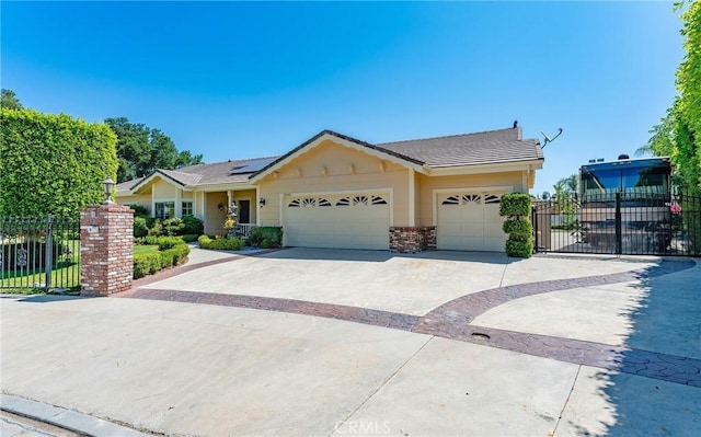 22501 Marilla St, Chatsworth, CA 91311 - ranch-style home with concrete driveway, roof mounted solar panels, a garage, brick siding, and a tile roof