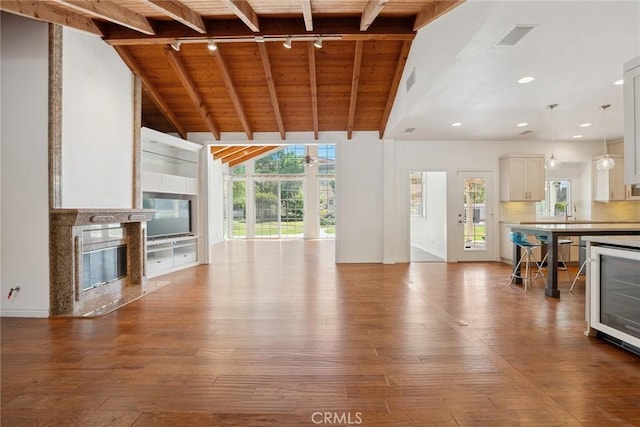 22501 Marilla St, Chatsworth, CA 91311 - unfurnished living room with rail lighting, wooden ceiling, a high end fireplace, hardwood / wood-style floors, and beverage cooler