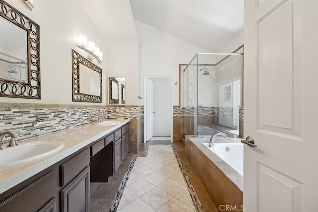 22501 Marilla St, Chatsworth, CA 91311 - full bath with a stall shower, double vanity, a garden tub, vaulted ceiling, and tasteful backsplash