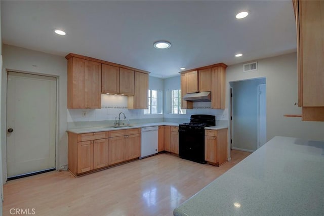 12911 Browning Ave, North Tustin, CA 92705 - kitchen featuring black gas range oven, dishwasher, light countertops, under cabinet range hood, and light wood-style floors
