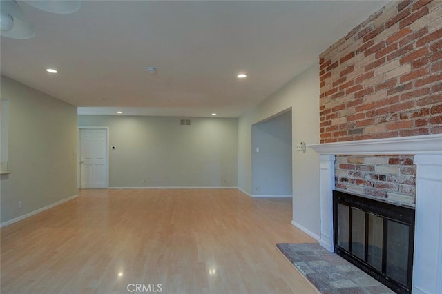 12911 Browning Ave, North Tustin, CA 92705 - unfurnished living room featuring a fireplace, light wood-style flooring, and recessed lighting