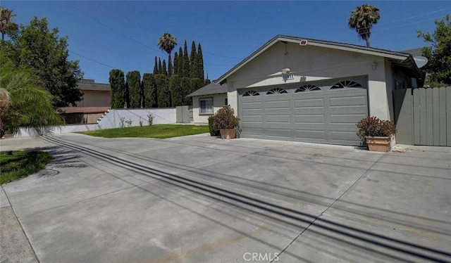 12911 Browning Ave, North Tustin, CA 92705 - view of front of house featuring concrete driveway, stucco siding, and a garage