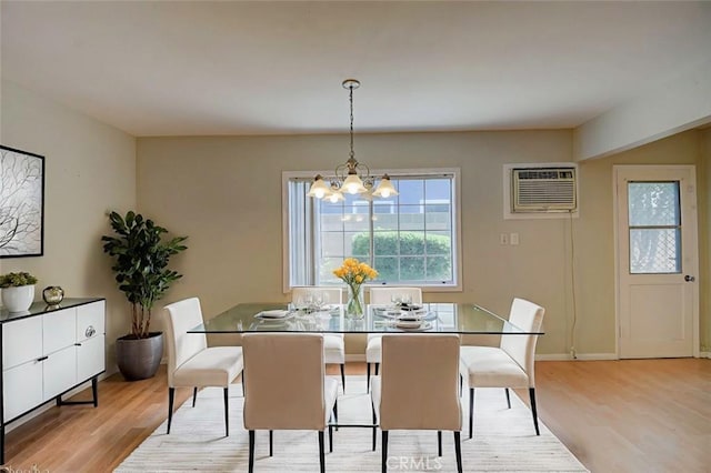 12911 Browning Ave, North Tustin, CA 92705 - dining area with an AC wall unit, a chandelier, and wood finished floors