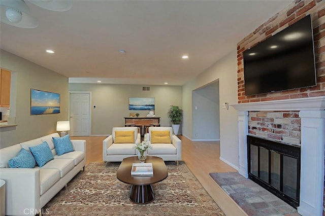 12911 Browning Ave, North Tustin, CA 92705 - living room with wood finished floors, a brick fireplace, and recessed lighting
