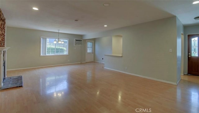 12911 Browning Ave, North Tustin, CA 92705 - unfurnished living room featuring light wood-type flooring, a chandelier, recessed lighting, and a brick fireplace