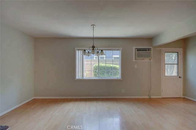 12911 Browning Ave, North Tustin, CA 92705 - unfurnished dining area featuring a chandelier, light wood-style flooring, and a wall mounted AC