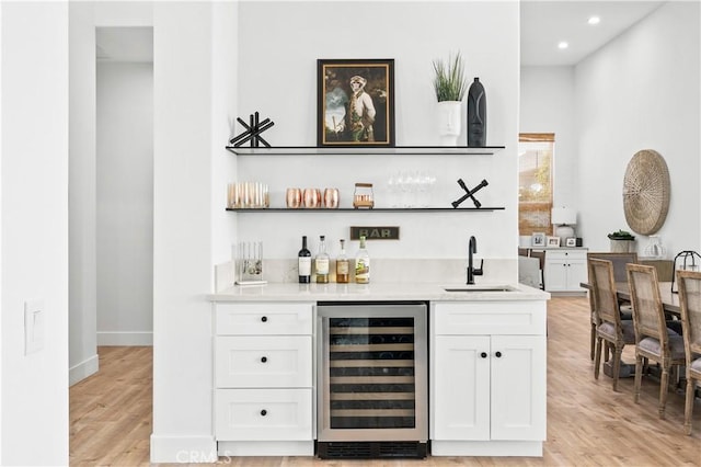 56610 Muirfield Ln, Quinta, CA 92253 - indoor wet bar featuring beverage cooler, light wood-style floors, and recessed lighting