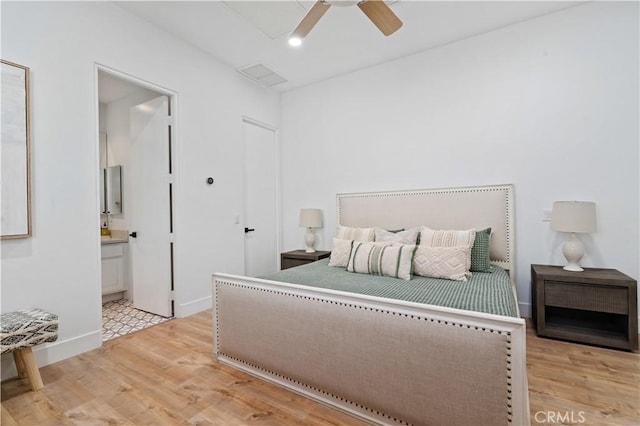 56610 Muirfield Ln, Quinta, CA 92253 - bedroom with light wood-style flooring, ensuite bathroom, and a ceiling fan