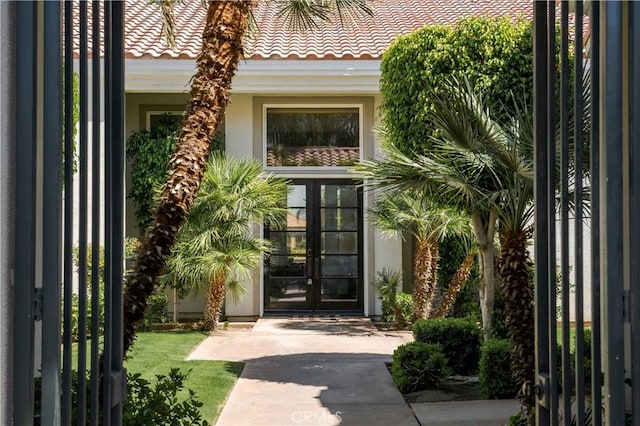 56610 Muirfield Ln, Quinta, CA 92253 - doorway to property with french doors, stucco siding, and a tiled roof