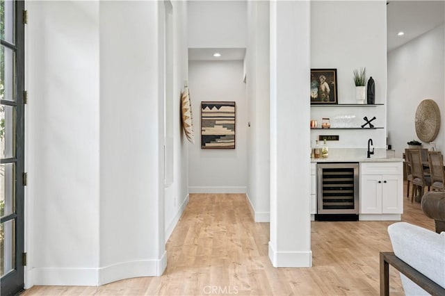 56610 Muirfield Ln, Quinta, CA 92253 - hallway with wine cooler, healthy amount of natural light, light wood-style flooring, and recessed lighting