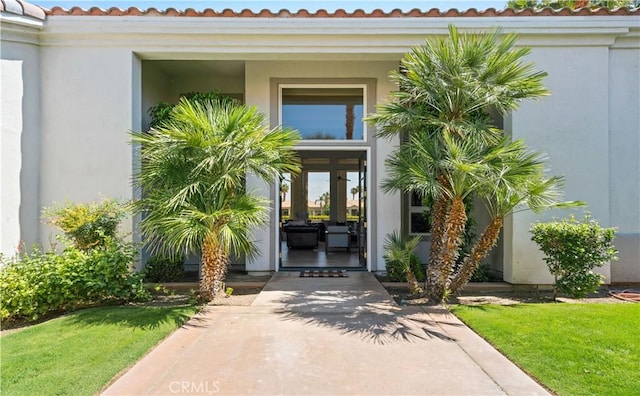 56610 Muirfield Ln, Quinta, CA 92253 - doorway to property featuring stucco siding and a yard