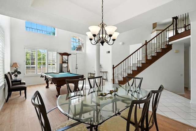 18103 Smokesignal Dr, San Diego, CA 92127 - dining space with a high ceiling, light wood-style flooring, stairway, pool table, and a chandelier