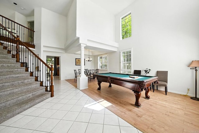 18103 Smokesignal Dr, San Diego, CA 92127 - playroom featuring a high ceiling, pool table, light tile patterned floors, decorative columns, and a chandelier