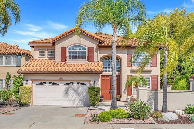 18103 Smokesignal Dr, San Diego, CA 92127 - mediterranean / spanish home with concrete driveway, stucco siding, an attached garage, and a tiled roof