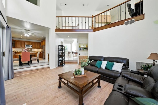 18103 Smokesignal Dr, San Diego, CA 92127 - living room with a high ceiling, light wood-type flooring, and a ceiling fan