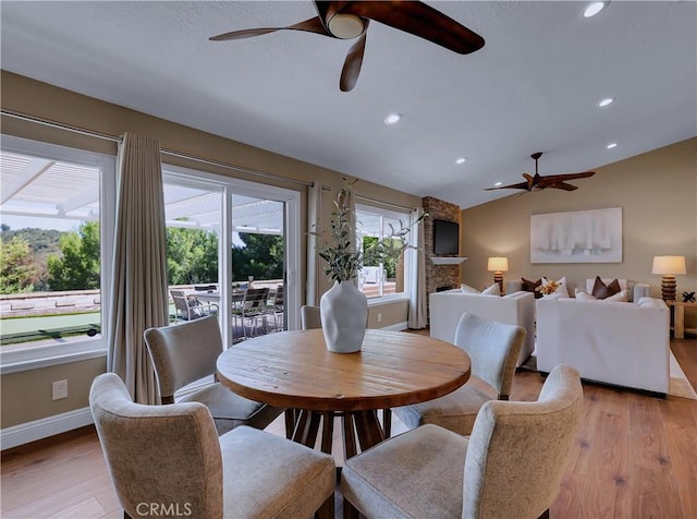 22182 Platino, Mission Viejo, CA 92691 - dining area with ceiling fan, light wood-type flooring, recessed lighting, a fireplace, and vaulted ceiling