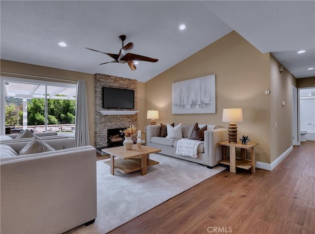 22182 Platino, Mission Viejo, CA 92691 - living room with wood finished floors, a ceiling fan, a stone fireplace, recessed lighting, and lofted ceiling