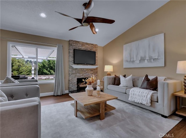 22182 Platino, Mission Viejo, CA 92691 - living area featuring ceiling fan, wood finished floors, a fireplace, and vaulted ceiling