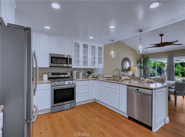 22182 Platino, Mission Viejo, CA 92691 - kitchen with appliances with stainless steel finishes, white cabinetry, a peninsula, light wood-type flooring, and recessed lighting