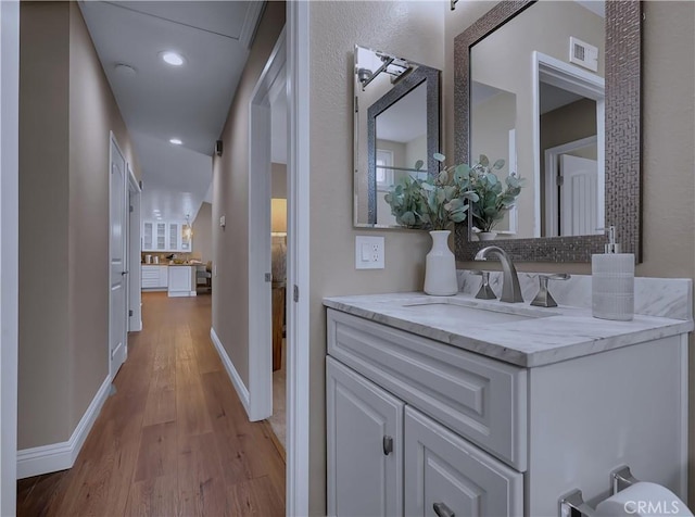 22182 Platino, Mission Viejo, CA 92691 - bathroom featuring wood finished floors, vanity, recessed lighting, and backsplash