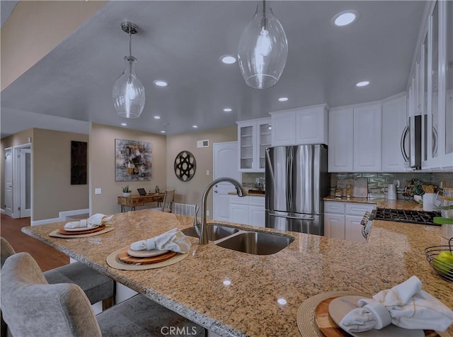 22182 Platino, Mission Viejo, CA 92691 - kitchen featuring stainless steel appliances, light stone countertops, white cabinets, recessed lighting, and a peninsula