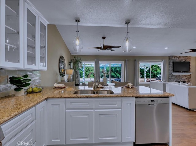 22182 Platino, Mission Viejo, CA 92691 - kitchen with stainless steel dishwasher, a ceiling fan, open floor plan, white cabinets, and a textured ceiling